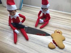 two elfs are sitting on the floor and one is holding a knife