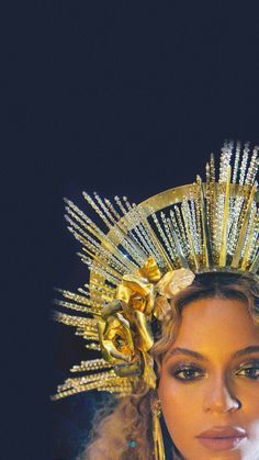 a woman wearing a gold crown and holding a cell phone