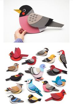 paper birds are being held by someone's hand and placed on top of each other