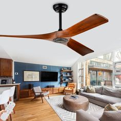 a living room filled with furniture and a flat screen tv mounted on the wall above a wooden ceiling fan