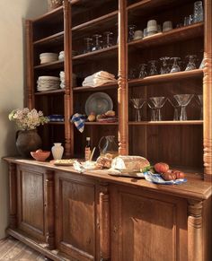 a large wooden cabinet filled with dishes and glasses