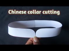 someone is holding up a paper collar with the words chinese collar cutting in front of it