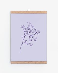 an illustration of a flower on a light purple background is framed in a wooden frame