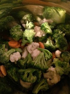 broccoli, cauliflower and carrots are mixed together in a bowl