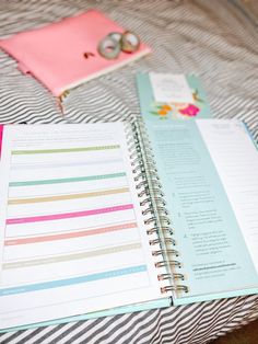 an open planner sitting on top of a bed