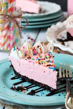 a piece of cake with sprinkles on it sitting on a blue plate