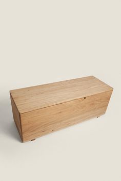 a wooden box sitting on top of a white surface