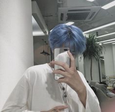 a person with blue hair taking a selfie