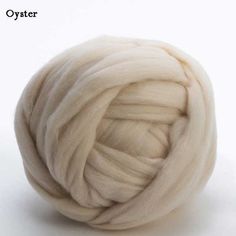 a white ball of yarn sitting on top of a white surface with the words oyster written above it