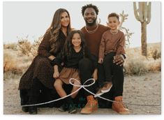 a family posing for a photo in the desert