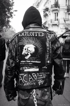 the back of a man wearing a leather jacket with writing on it and an eagle