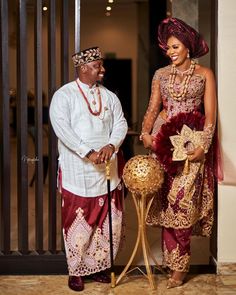 two people standing next to each other in front of a doorway