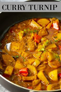 curry turnip in a pan with spoons and garnish on the side