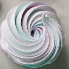 a close up view of a white and blue swirled doughnut