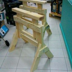 a wooden chair sitting on top of a white tile floor in a store next to a bbq grill