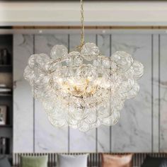 a chandelier hanging from the ceiling in a living room