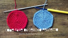 two crocheted circles sitting on top of a wooden table next to knitting needles