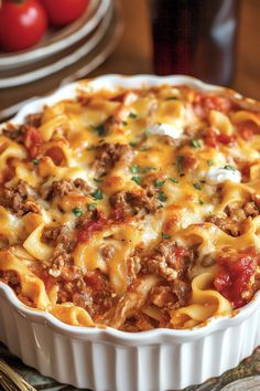 a casserole dish with meat, cheese and sauce in it on a table