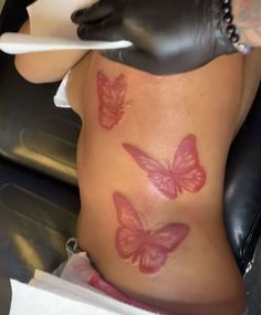 a woman with tattoos on her stomach and butterflies painted on the side of her body