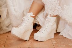 the bride's shoes are all white and have lace on them