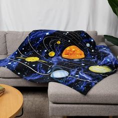 the solar system blanket is sitting on a couch