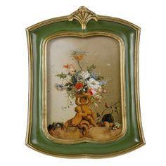 an ornate framed painting with flowers in it