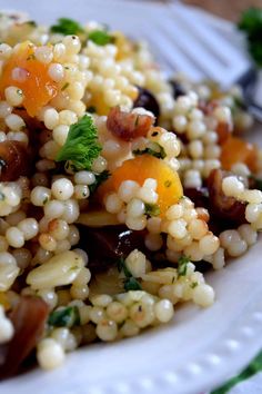 a white plate topped with corn and vegetables