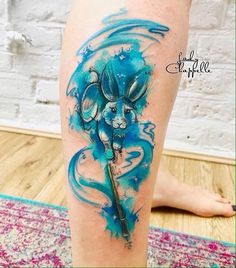 a blue ink tattoo on the leg of a woman