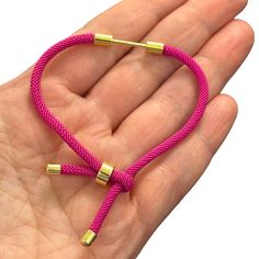 Discover elegance and versatility with our 24Kt Gold Plated Fuchsia Cord Bracelet Blank. Crafted with precision, this bracelet features an innovative screw clasp positioned at its center, allowing effortless customization. Simply pull the stopper at the end to reveal the open clasp, facilitating easy embellishment. You can see it open in the second picture with your favorite charms and beads. Enhance your style with endless possibilities - whether you prefer minimalist chic or vibrant statement Bracelet Cord, Bracelet Cordon, Minimalist Chic, Cordon Bleu, Cord Bracelet, 24kt Gold, Cord Bracelets, The End, 1 Piece