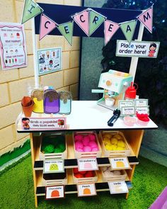 an ice cream stand with lots of different colored items on it's display shelf