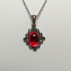 This Simple Necklace Features Tiny Swarovski Crystals In Red And Green With Vintage Lucite Cabochons Also In Red And Light Green . Necklace Matches Earrings That Are Listed In This Closet. Chain Is About 19" With A Cute Heart Toggle Clasp, All In Antique Silver-Plate. Pendant Portion Is About 1 1/4" From The Top Of The Bail (The Piece That Connects To The Chain). Handmade With Love In Ca! #165 Vintage Lucite Necklace Christmas Crystal Necklace Gift, Christmas Gift Crystal Necklace, Red Crystal Necklace For Gift, Red Pendant Necklace For Christmas, Elegant Red Necklace For Christmas, Red Birthstone Jewelry For Party, Elegant Red Christmas Necklace, Red Necklace For Holiday Party, Red Holiday Party Necklace