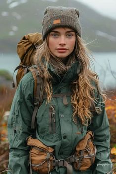 a woman with long hair wearing a green jacket and hat