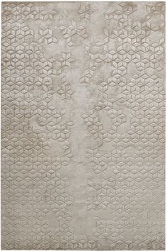 a white rug with an intricate design on the bottom, and a light gray background