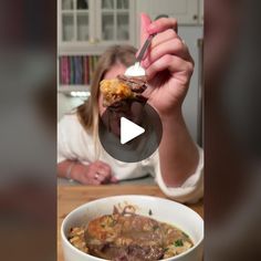 a woman eating food from a white bowl