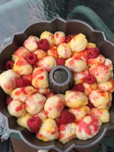 a cake pan filled with raspberries and other desserts