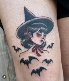 a woman wearing a witches hat with bats on her thigh