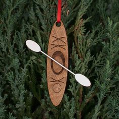 an ornament hanging from a tree with two spoons