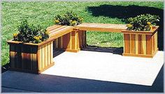 two planters with yellow flowers are sitting on a bench in the middle of a yard