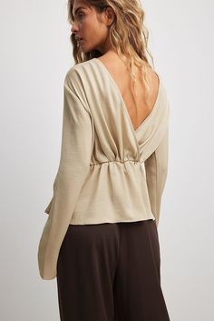 This blouse features a soft smooth touch and a relaxed fit with an elasticized waist. It has a draping design, a deep v backline and an inner silicone trim at the shoulders. This blouse features a flowy bottom hem. Draping Design, Draped Blouse, Designer Drapes, Future Fashion, Na Kd, Deep V, Women Empowerment, Champagne, Relaxed Fit