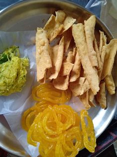 a metal plate topped with different types of food