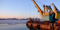 a large crane sitting on top of a body of water