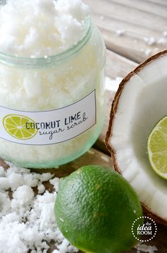 coconut lime sugar scrub in a glass jar next to a sliced lime