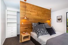 a bedroom with wood paneling and white walls