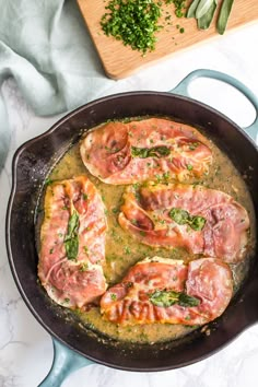 a skillet filled with meat covered in sauce