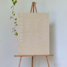 a wooden easel with a seating chart on it