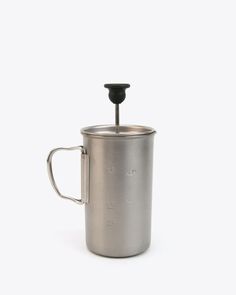 a stainless steel french press coffee maker with a lid and handle on a white background