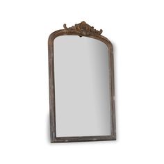 an ornate wooden mirror hanging on the wall