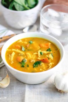 a white bowl filled with chicken and vegetable soup