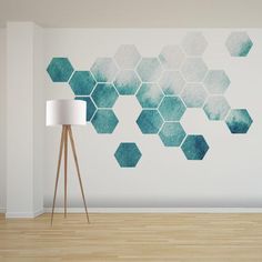 a room with a lamp and wallpaper that has blue hexagons on it