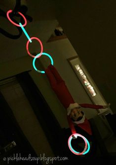 an elf is playing with some light up circles